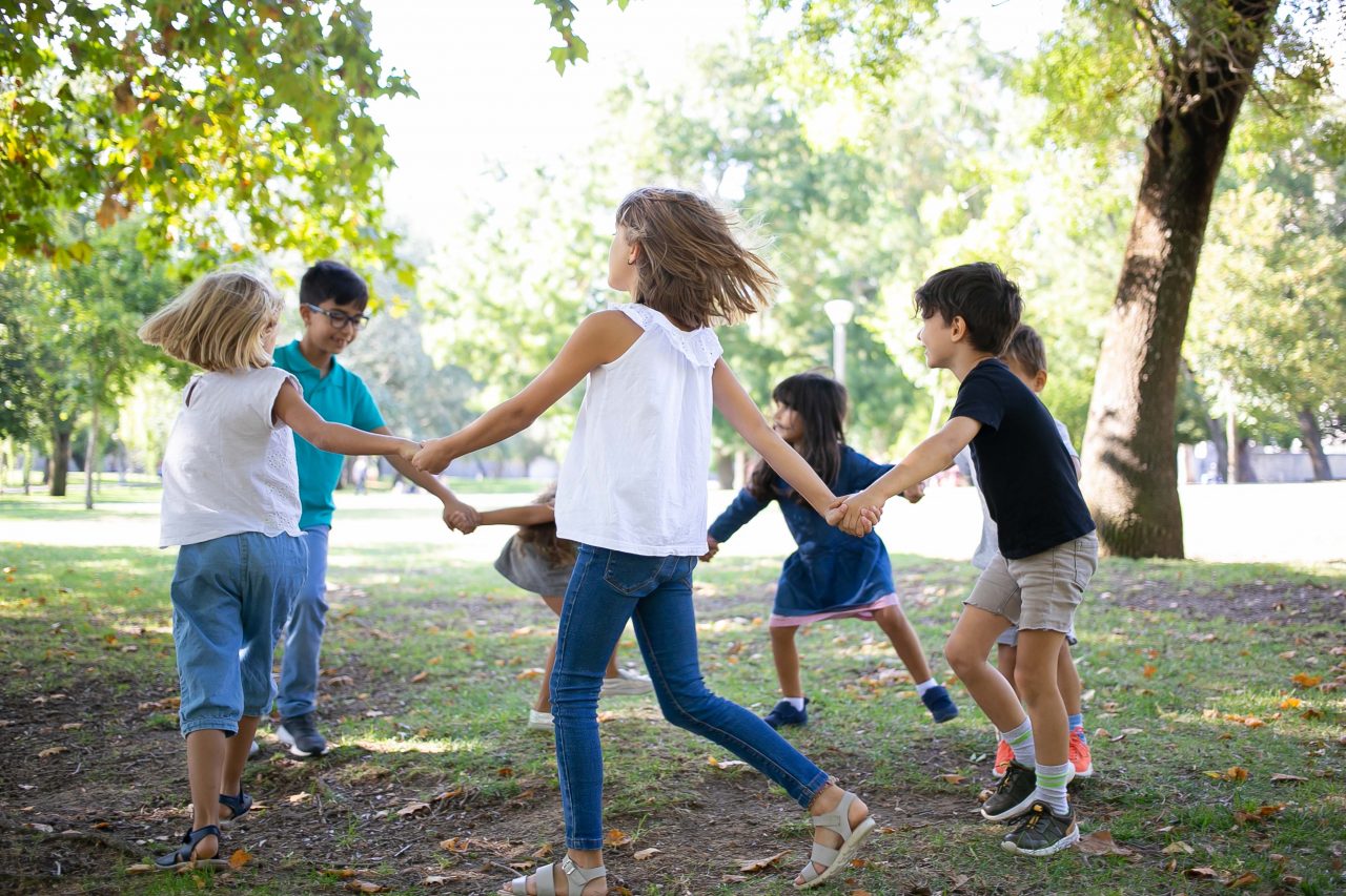 group-children-holding-hands-dancing-around-enjoying-outdoor-activities-having-fun-park-kids-party-friendship-concept-Smaller-1280x853.jpg